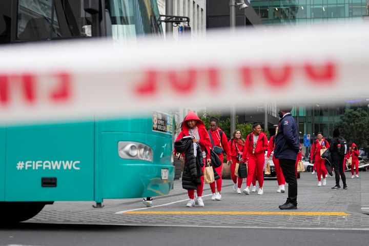 Members of the Philippines Women's World Cup team walk to their team bus following a shooting near their hotel in the central business district in Auckland,New Zealand, Thursday, July 20, 2023. A gunman killed two people before he died Thursday at a construction site in Auckland, as the nation prepared to host games in the FIFA Women's World Cup soccer tournament.(AP Photo/Abbie Parr)