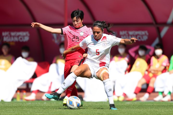 Hali Long of the Philippines controls the ball under pressure from Son Hwanyeon of South Korea during the AFC Women's Asian Cup semi-final in 2022.