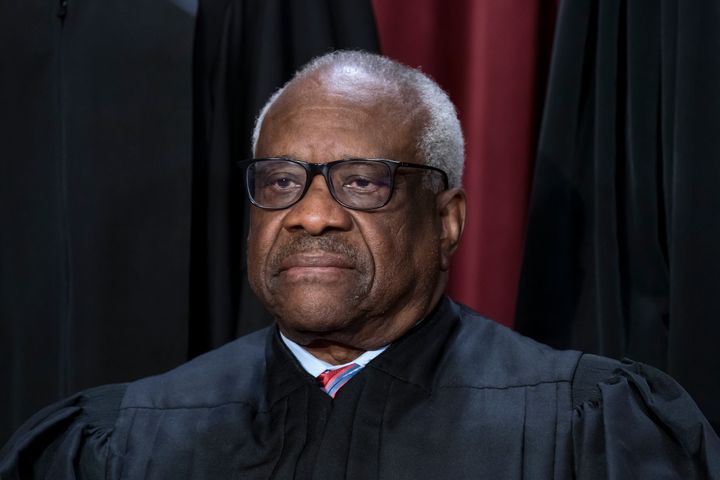 Associate Justice Clarence Thomas joins other members of the Supreme Court as they pose for a new group portrait, at the Supreme Court building in Washington, Oct. 7, 2022. 