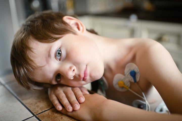 Little boy with heart holter at home