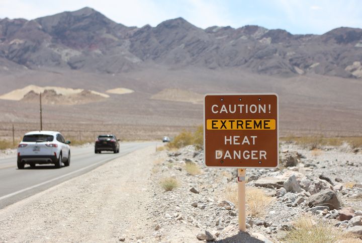 A heat advisory sign along US highway 190 during a heat wave in California's Death Valley National Park on July 16, 2023.