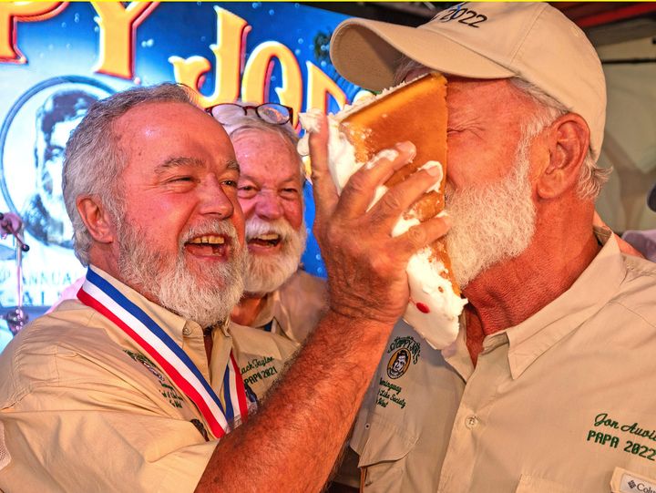 Zach Taylor, the 2021 "Papa" Hemingway Look-Alike Contest winner, shoves birthday cake into the face of 2022 winner Jon Auvil, Thursday, July 20, 2023, on the eve of Ernest Hemingway's 124th birthday anniversary, at Sloppy Joe's Bar in Key West, Fla. 