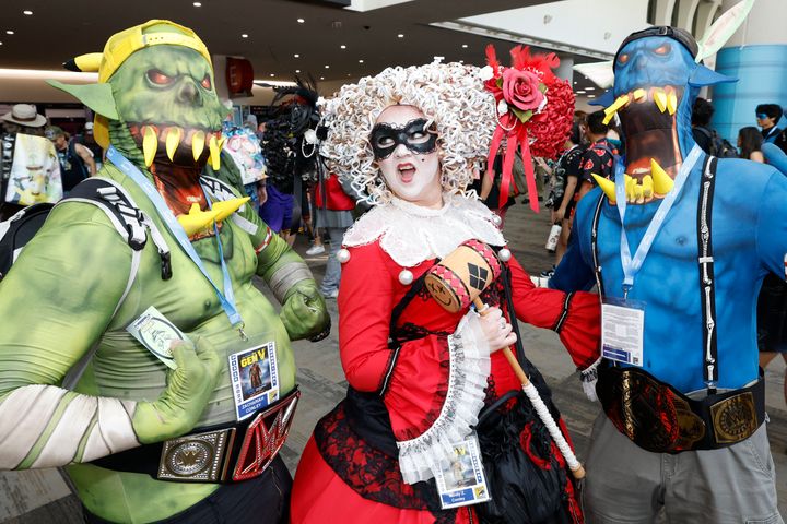 Denver residents Zachariah Conley, left, and Elijah Conley, right, dressed as Da Orks, and Mindy Conley, dressed as Harley Quinn.