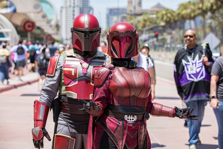 Marvel inspired Mandalorian cosplayers Miguel Capuchino (L) and Lucy Capuchino