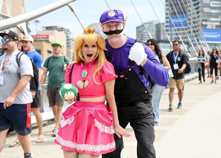 Cosplayers dressed as Princess Peach and Waluigi from "Super Mario Bros" at the 2023 Comic-Con International