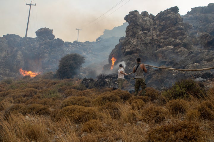 Firefighter teams intervene a wildfire across Greece's Rhodes island on July 22, 2023. 