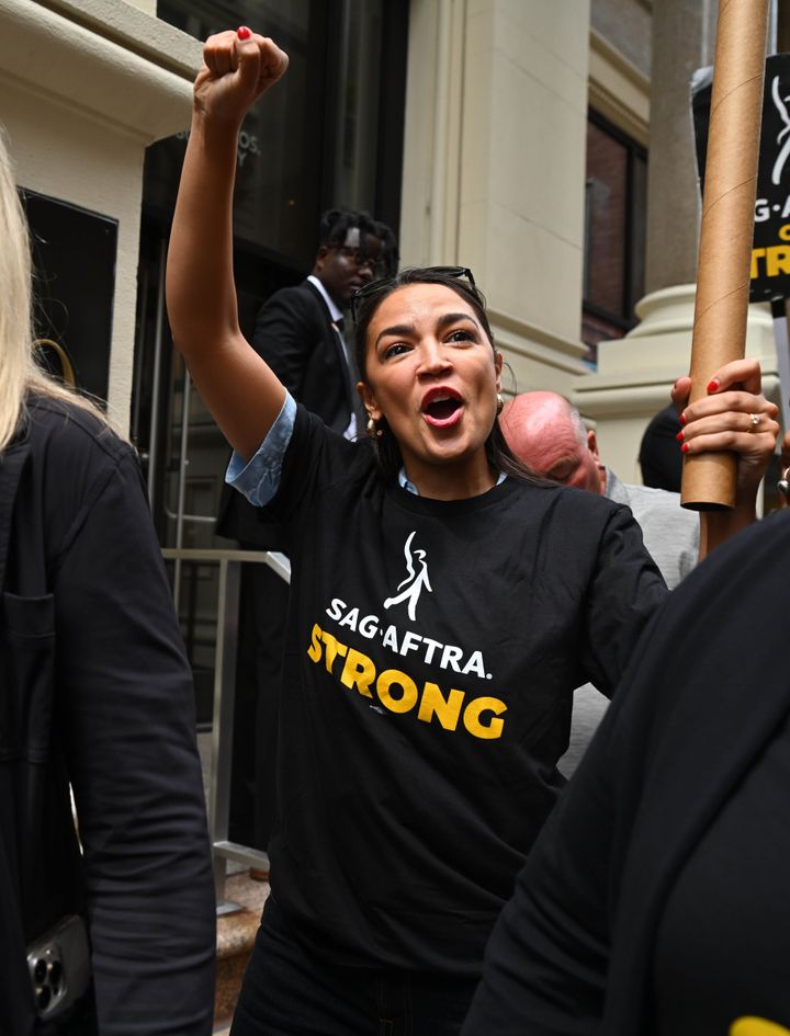 Rep. Alexandria Ocasio-Cortez (D-N.Y.) walks the picket line in support of the SAG-AFTRA and WGA strikes on July 24 in New York City.