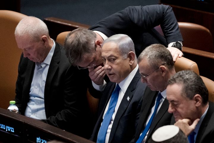 Lawmakers surround Israel's Prime Minister Benjamin Netanyahu, center, at a session of the Knesset, Israel's parliament, in Jerusalem, on July 24, 2023. 