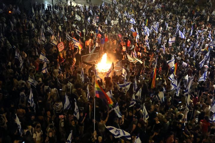Demonstrators gather around a bonfire as they block a highway during a protest against the Israeli government's judicial reform plan in Tel Aviv on July 24, 2023.