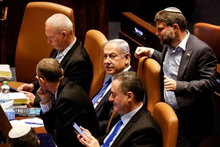 Israeli Prime Minister Benjamin Netanyahu and lawmakers gather at the Knesset plenum to vote on a bill that would limit some Supreme Court power, in Jerusalem, July 24, 2023. 