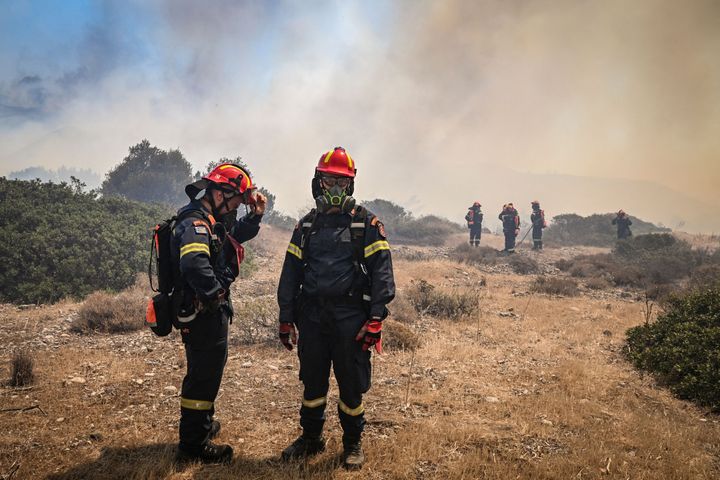 Greek firefighters work to extinguish wildfires near the village of Vati, just north of the coastal town of Gennadi, in the southern part of the Greek island of Rhodes, on July 25, 2023. 