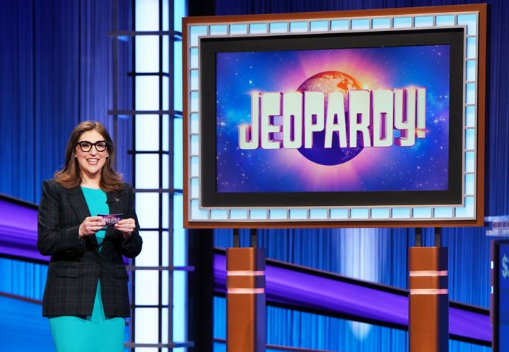 Mayim Bialik, one of the hosts of "Jeopardy!" The long-running game show said it's delaying its annual Tournament of Champions until studio executives reach a fair deal with WGA writers after seven recent champions said they would not cross a picket line to participate.