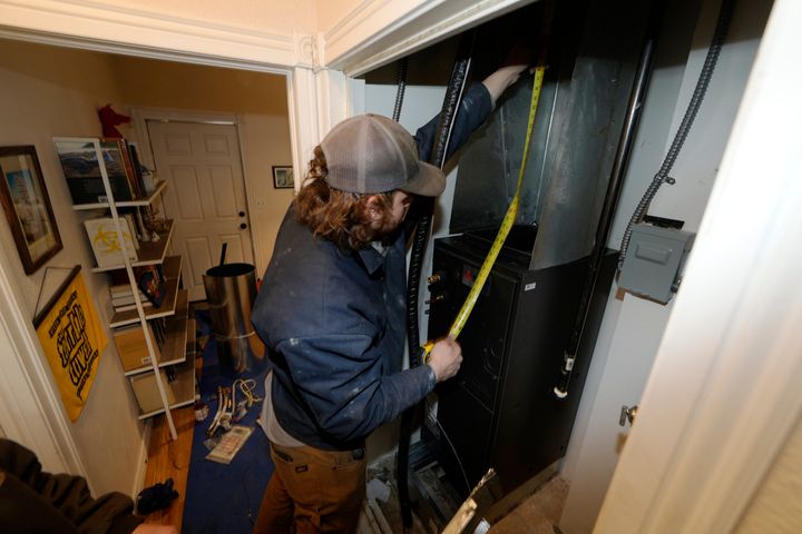 A heat pump is installed in an 80-year-old rowhouse in northwest Denver in early 2023.