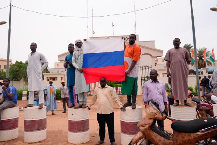 Supporters of mutinous soldiers hold a Russian flag as they demonstrate in Niamey, Niger, onJuly 27, 2023.