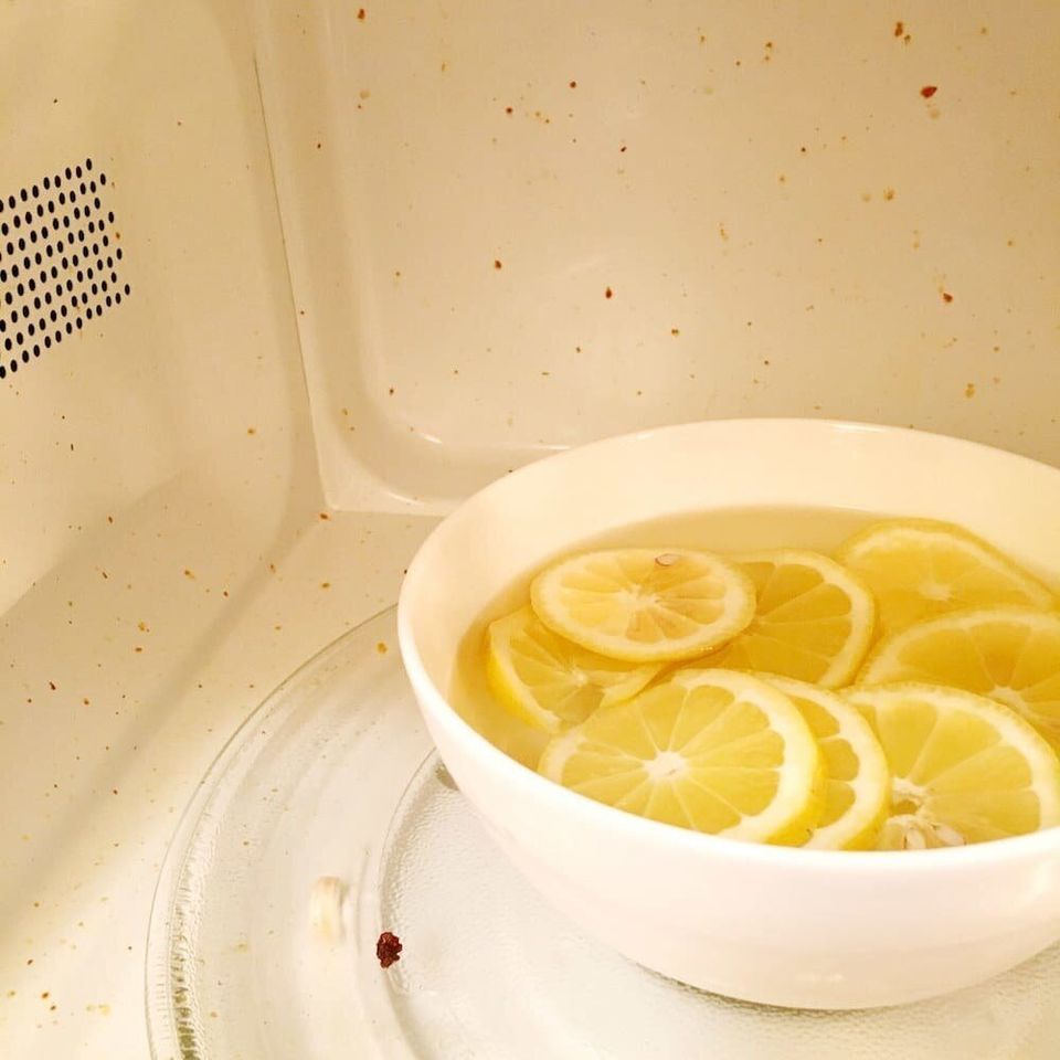 Microwave a bowl filled with water + lemon for 3–5 minutes — then leave the door closed for a few minutes so everything can steam — and you'll be able to wipe off every single dried-on food bit with one swipe of a paper towel.