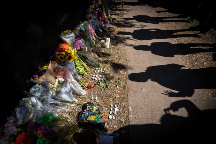 FILE - Visitors cast shadows at a memorial to the victims of the Astroworld concert in Houston on Nov. 7, 2021. The crowd surge at the festival in Houston killed 10 attendees who ranged in age from 9 to 27.