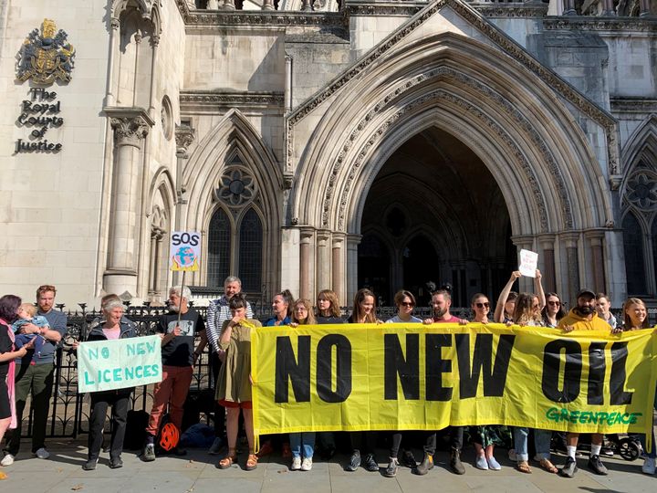 Protestors gather outside the Royal Courts of Justice in London ahead of a legal challenge from environmental campaign groups over the Government's opening of a new round of oil and gas extraction licencing in the North Sea in July 2023.