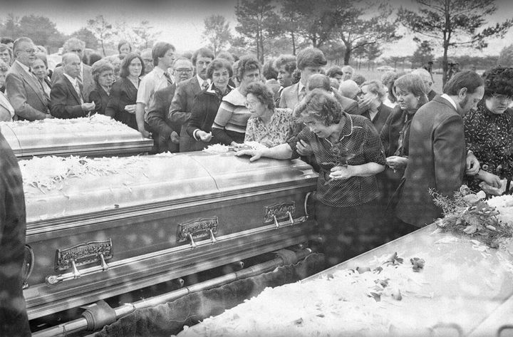 Helena Tarasewicz, foreground, right, mother of Tylenol cyanide victim Theresa Tarasewicz Janus, weeps over the casket containing her daughter's body during graveside services at Maryhill Cemetery in Niles, Illinois, on Oct. 6, 1982.