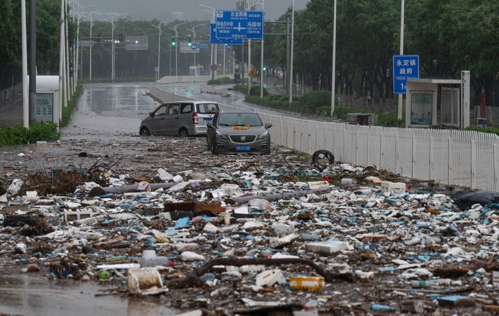 Floating waste and debris are seen after flood water recedes in Mengtougou district on July 31, 2023 in Beijing.
