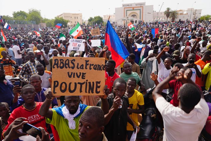 Nigeriens participate in a march called by supporters of coup leader Gen. Abdourahmane Tchiani in Niamey, Niger, on July 30, 2023. The French Foreign Ministry says Tuesday, Aug.1, 2023 France is planning an imminent evacuation of people seeking to leave Niger after the coup last week in the former French colony. Poster reads: "Down with France, long live Putin." 