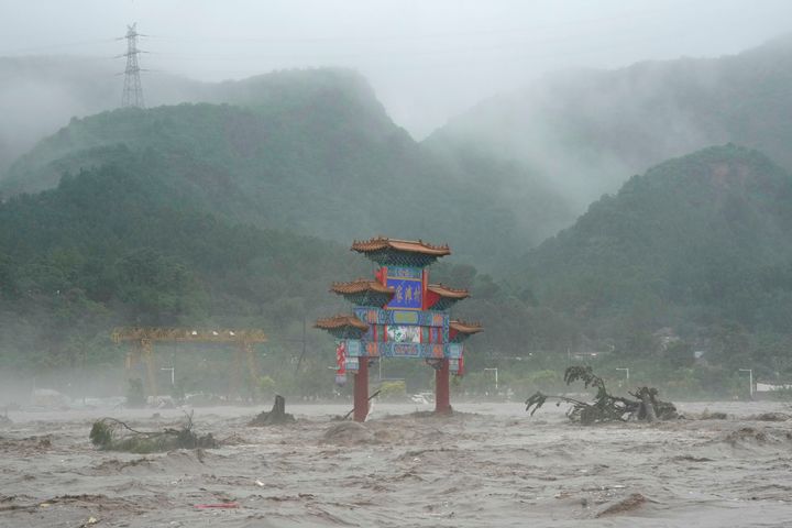 A traditional gate is seen inundated by flood waters in the Miaofengshan area on the outskirts of Beijing, August 1, 2023. 