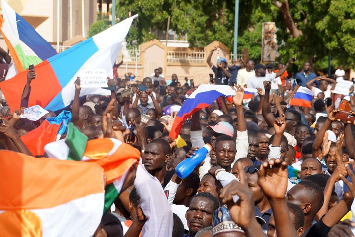 Coup supporters unfurl a Russian flag as they take to the streets after the army seized power in Niamey, Niger, on July 30, 2023. 