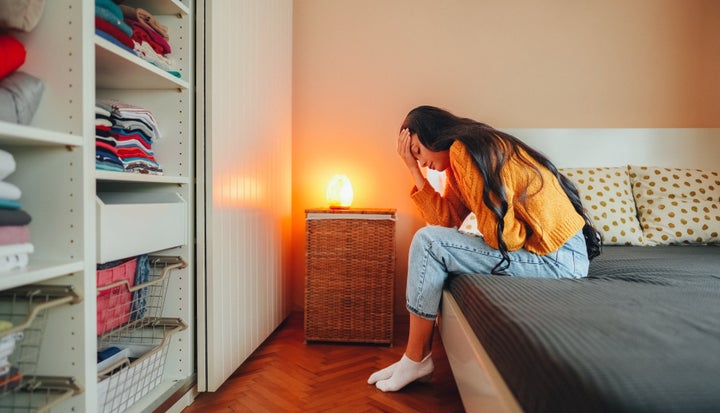 Woman with painful menstruation resting in bed