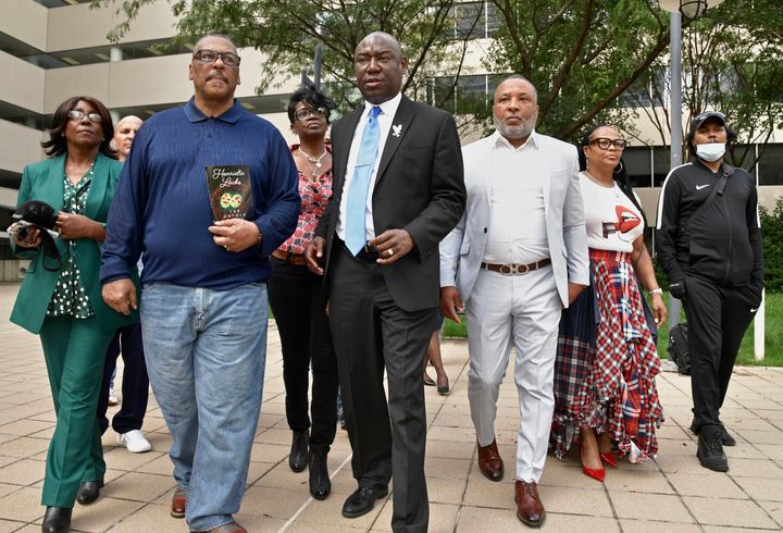 Attorney Ben Crump, middle, surrounded by four grandchildren of Henrietta Lacks and two spouses, head to an October 2021 news conference outside the Edward A. Garmatz U. S. District Courthouse to announce the filing of a lawsuit against Thermo Fisher Scientific, Inc., a multibillion-dollar biotechnology corporation, on behalf of the estate of Henrietta Lacks in Baltimore. From left, Hope and Ron Lacks, Kimberley Lacks, Crump, Alfred Lacks Carter with his wife, Jewel Carter, and Jason O'Neal.