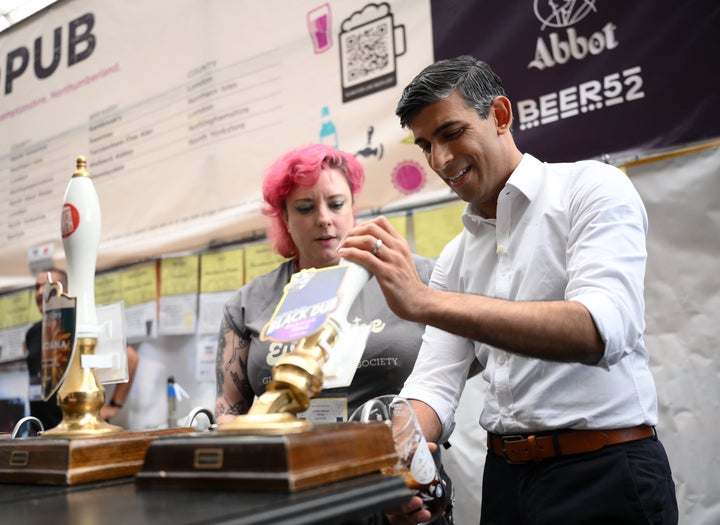 Rishi Sunak pours a pint of Black Dub stout during a visit to the Great British Beer Festival.