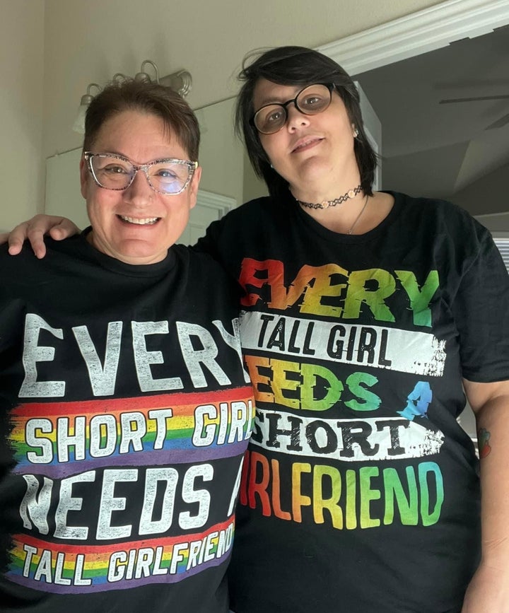 The author (left) with her girlfriend, Joy Jenkins. "We gave each other these T-shirts and took this picture a week before my cancer diagnosis," she writes. "I'm 5'2" and Joy is 5'8"."