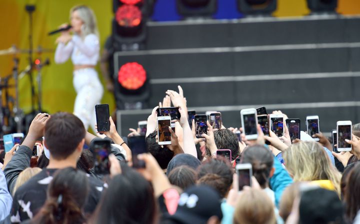 Fan culture — and the need to document everything on social media — may play a part in this trend. Here, fans record with their phones as Halsey performs in New York City's Central Park in 2018.