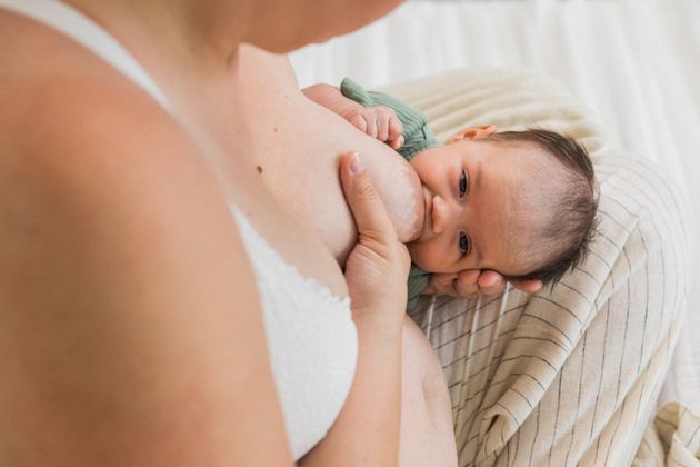 A baby feeding in the rugby position.