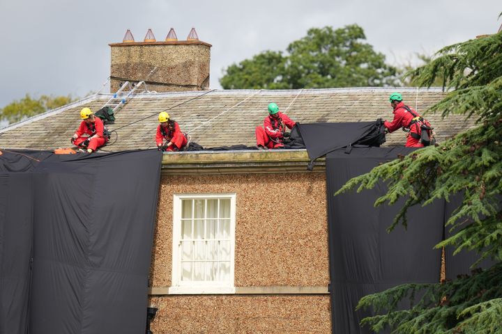 Greenpeace activists moving fabric on the roof of Prime Minister Rishi Sunak's house in Richmond, North Yorkshire.