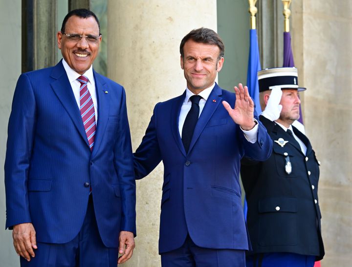 French President Emmanuel Macron (R) greets Niger's President Mohamed Bazoum as he arrives for a meeting at the Elysee Palace, amid the New Global Financial Pact Summit in Paris on June 23, 2023.