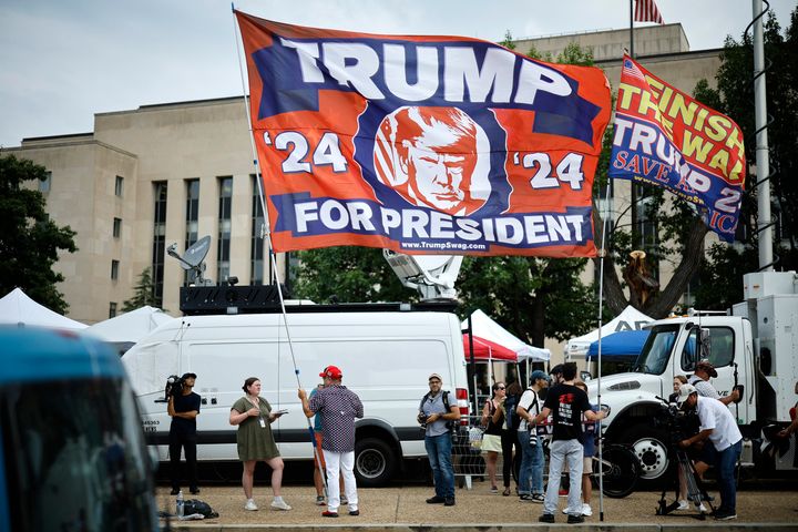Trump supporters wave flags outside the E. Barrett Prettyman U.S. District Court House ahead of Donald Trump's arrival on Aug. 3, 2023, ahead of his scheduled arraignment in Washington, D.C.