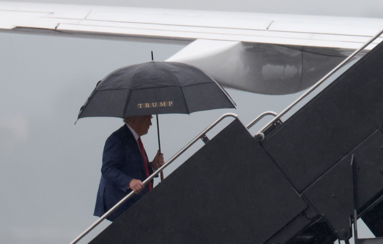 Trump boards his plane following the arraignment.