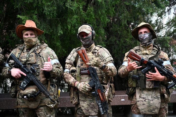 Fighters of Wagner private mercenary group pose for a picture as they get deployed near the headquarters of the Southern Military District in the city of Rostov-on-Don, Russia, June 24, 2023.