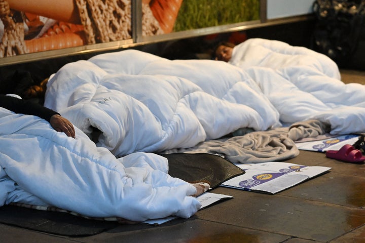 Rough sleepers lay in their makeshift beds outside closed shops on Oxford Street, at daybreak in London on August 2, 2023.