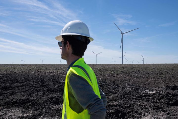 An Engie employee looks out toward the wind turbines during a tour for the dedication of the Limestone Wind Project in Dawson, Texas, on Feb. 28.