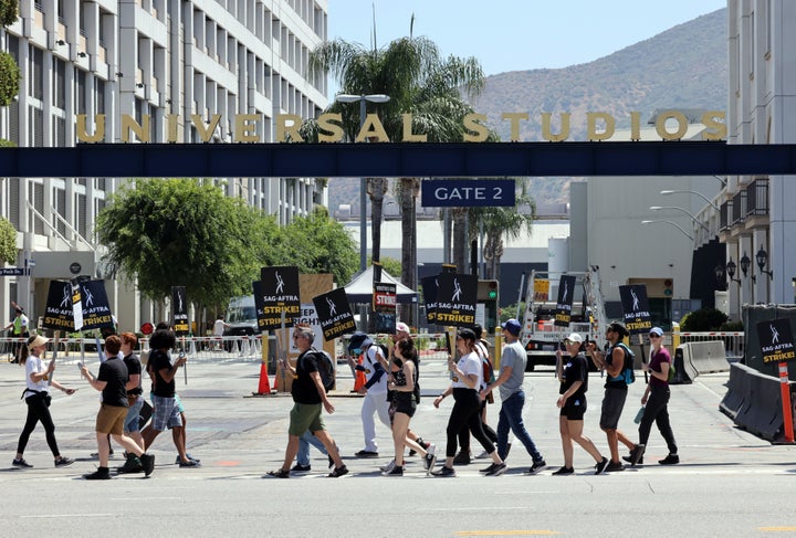 UNIVERSAL CITY - AUGUST 04: Members and supporters of SAG-AFTRA and WGA walk the picket line at Universal Studios on August 04, 2023 in Universal City, California. Members of SAG-AFTRA and WGA (Writers Guild of America) have both walked out in their first joint strike against the studios since 1960. The strike has shut down a majority of Hollywood productions with writers in the third month of their strike against the Hollywood studios. (Photo by David Livingston/Getty Images)