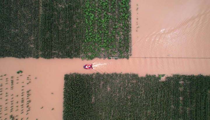 ZHUOZHOU, CHINA - AUGUST 03: Rescuers use rubber boat to transfer trapped people after days of downpours brought by Typhoon Doksuri on August 3, 2023 in Zhuozhou, Hebei Province of China. Persistent severe rainstorms brought by Typhoon Doksuri have caused extensive flooding in Zhuozhou. (Photo by Zhai Jujia/China News Service/VCG via Getty Images)