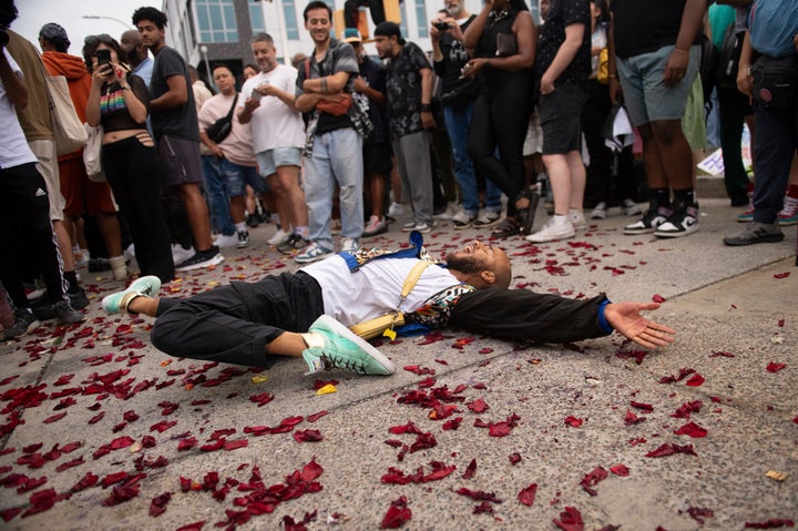 People dance in vogue style during a vigil to memorialize O'Shae Sibley at a gas station in Brooklyn, New York on Friday. Sibley, a gay man, was fatally stabbed at the gas station after a confrontation between a group of friends dancing to a Beyoncé song and several young men who taunted them.