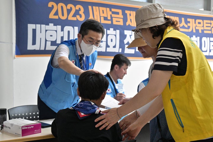 A scout (C) registers at the medical center of the World Scout Jamboree in Buan, North Jeolla province on Aug. 5, 2023. American and British scouts pulled out of the World Scout Jamboree in South Korea, citing scorching temperatures.