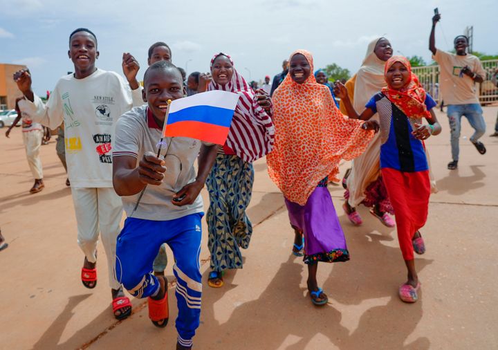 Supporters of Niger's ruling junta hold a Russian flag in Niamey, Niger, on Aug. 6, 2023. Nigeriens are bracing for a possible military intervention as time's run out for its new junta leaders to reinstate the country's ousted president.