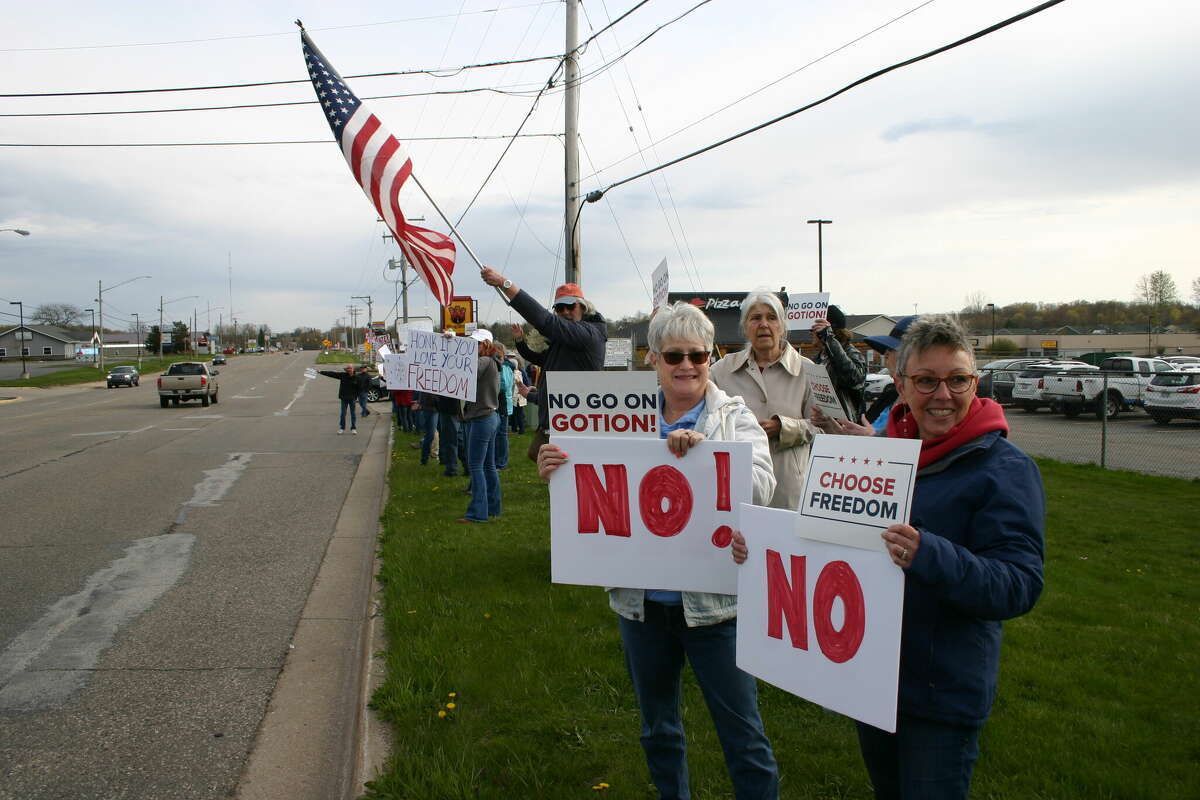 Anti-Gotion protesters wave to traffic during a spring demonstration in Big Rapids, Green Township’s larger neighbor to the south.