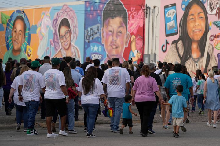 Mourners walk next to a mural of the shooting victims before a candlelight vigil in Uvalde, Texas, on May 24, 2023. Fourteen months ago a gunman killed 19 children and two teachers inside a fourth grade classroom.