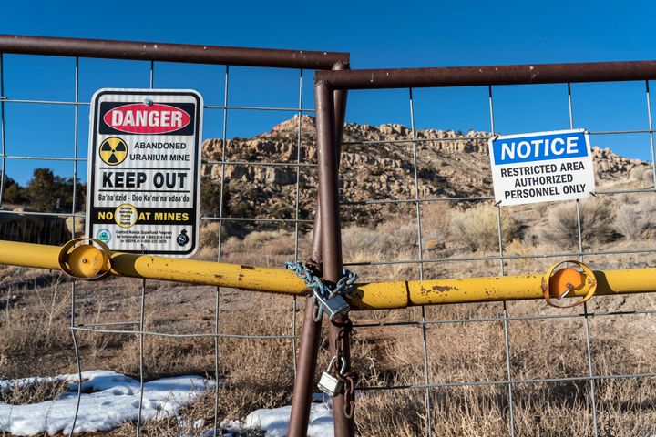 Signs warning of health risks are posted outside the gates of an abandoned uranium mine in the community of Red Water Pond, New Mexico, in January 2020.
