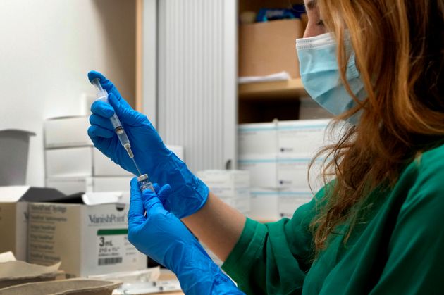 A Covid-19 vaccine is prepared at St Charles' Centre for Health and Wellbeing in London.