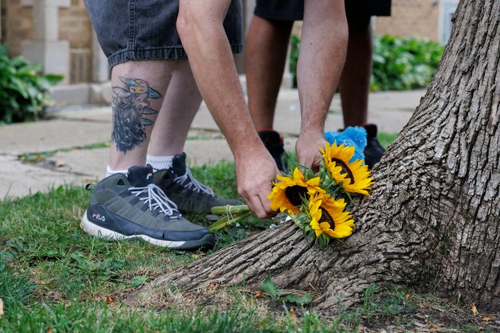 James, lays down flowers where a 9-year-old Chicago girl was killed in Portage Park, Aug. 6, 2023.