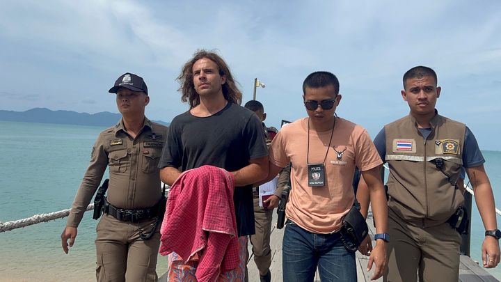 Sancho is escorted by Thai police on Monday after being arrested on charges of murder in the death and dismemberment of Edwin Arrieta Arteaga.